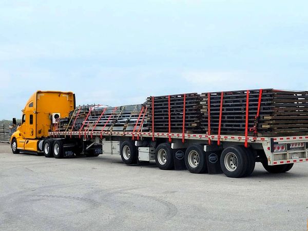 heavy haul truck transporting oversized over-dimensional equipment cargo; flatbed; step deck; RGN