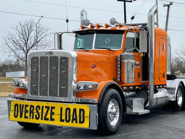 heavy haul truck transporting oversized over-dimensional equipment cargo; flatbed; step deck; RGN