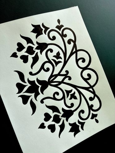Black floral pattern drawn on white paper.