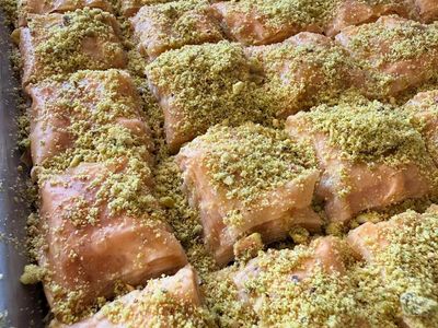 Freshly baked baklava topped with crushed pistachios.