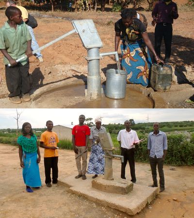 People using and standing by water pumps in a rural area.