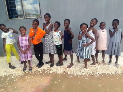 Row of standing smiling children