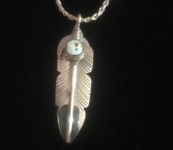 A feather pendant with a Dry Creek stone