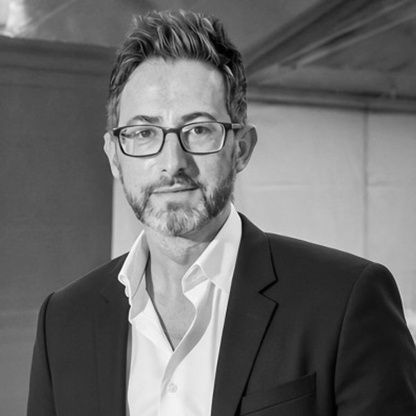 Man in glasses and suit jacket