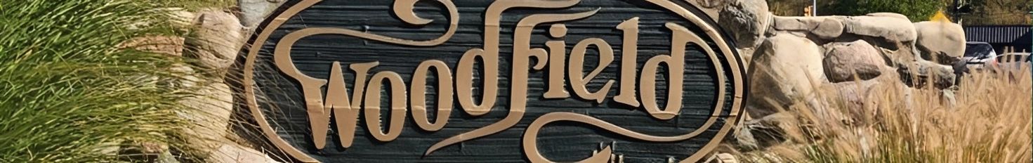 Woodfield neighborhood entrance stone sign.