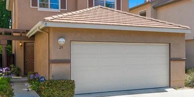 Modern house with a two-car garage and beige exterior.