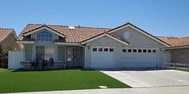 Single-story suburban house with a tiled roof and a large garage.