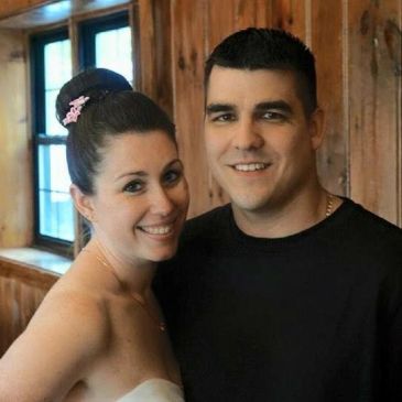 Smiling couple posing indoors.