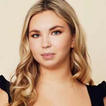 Portrait of a woman with blonde hair and subtle makeup.