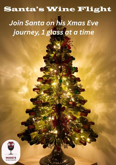 Christmas tree made of wine bottles illuminated with lights.