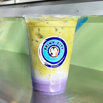 Colorful iced drink with purple and green layers in a clear cup.