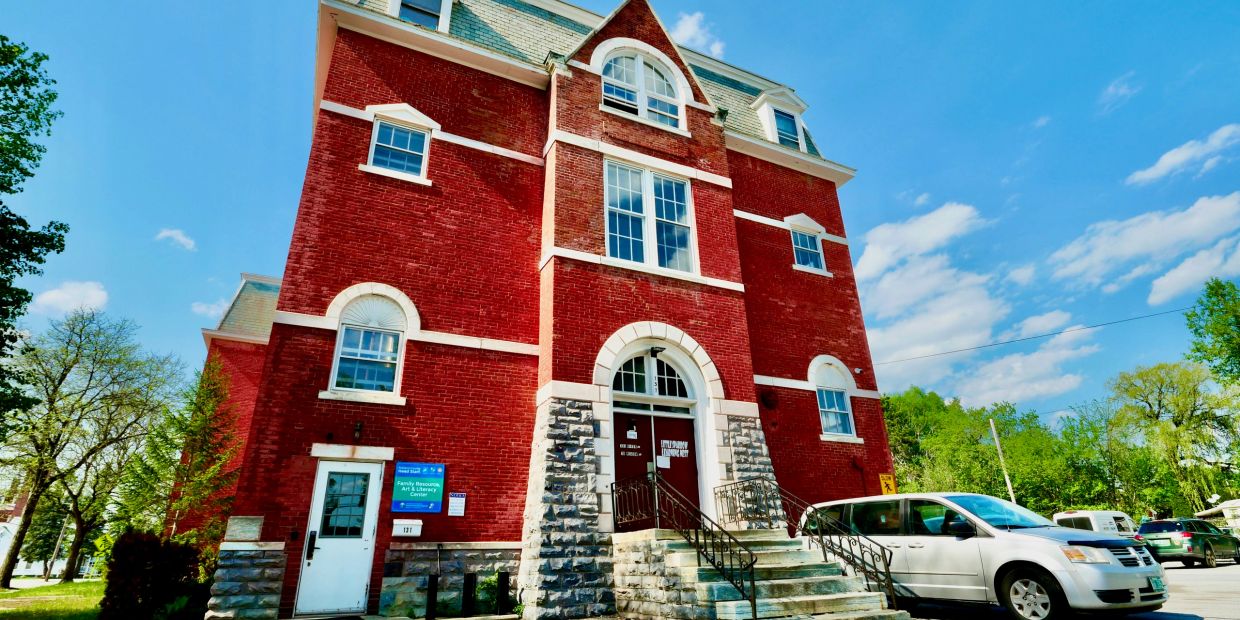 Red brick community art and literacy center building.