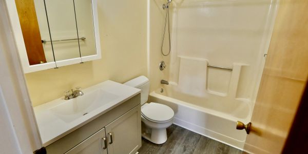 Small bathroom with bathtub, sink, and toilet.