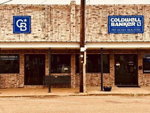 Caldwell Banker building in Crockett, TX. Commercial metalwork and custom architectural signage.
