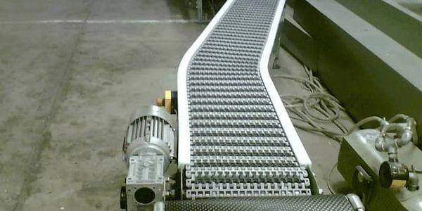 Side flexing modular belt conveyor to transport pocket diaries.