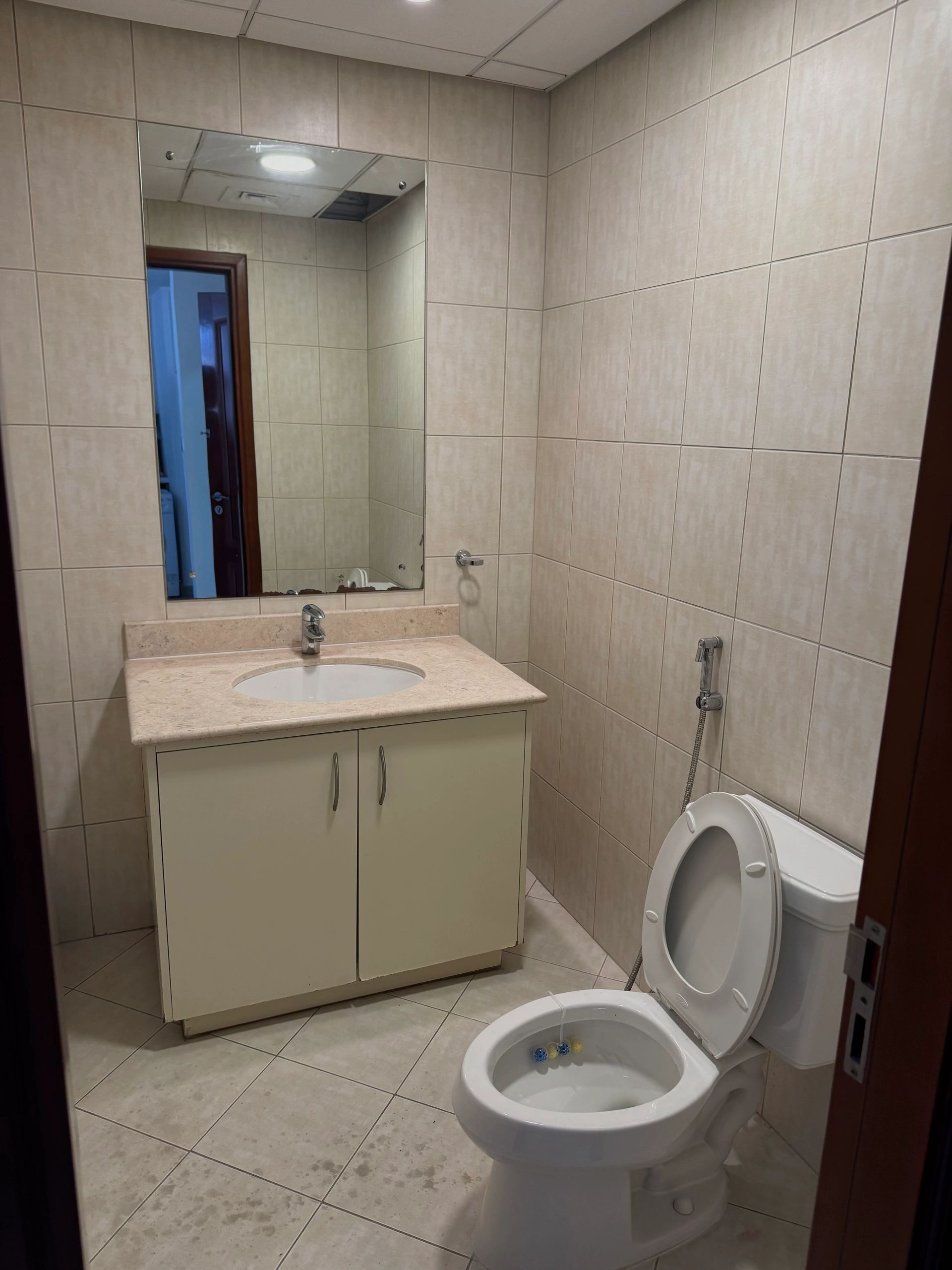Clean bathroom with beige tiles and modern fixtures.