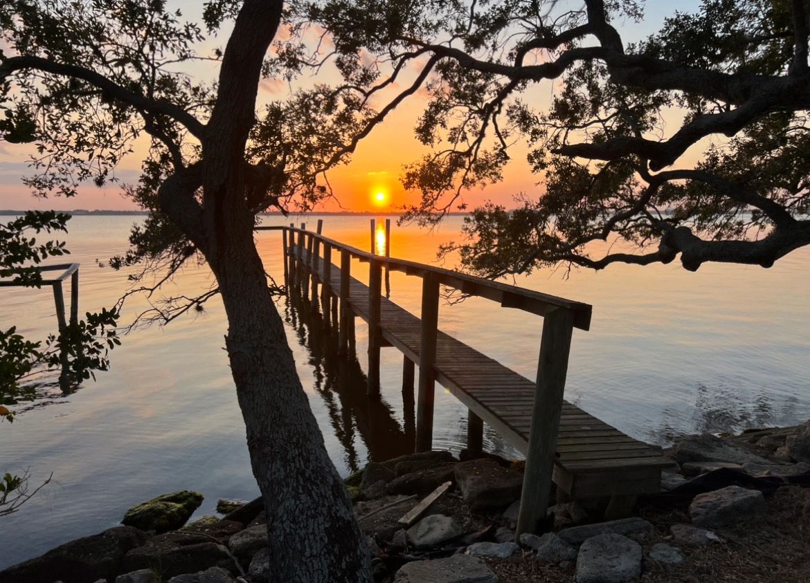 Sunset over old dock by the river