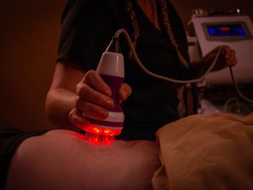 Red light therapy being applied to a person's body.