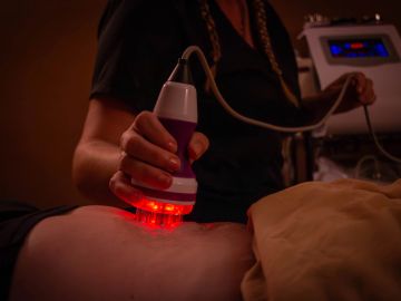 Red light therapy being applied to a person's body.