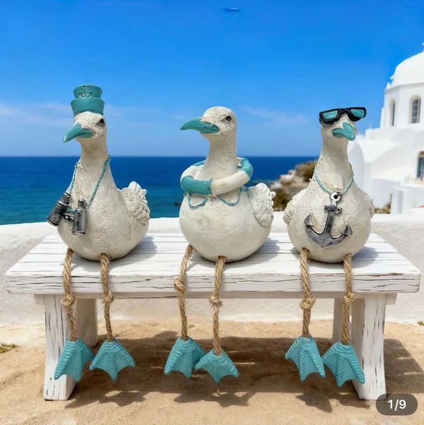 Carved Seagull that sits on any shelf with an anchor around his neck