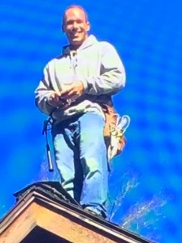 Keith Nagy, owner of Nagy Roof and Repair walking a roof during an inspection.