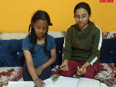 Experienced tutor with student at their home during class in Bhopal Quality Teaching Highly Educateda