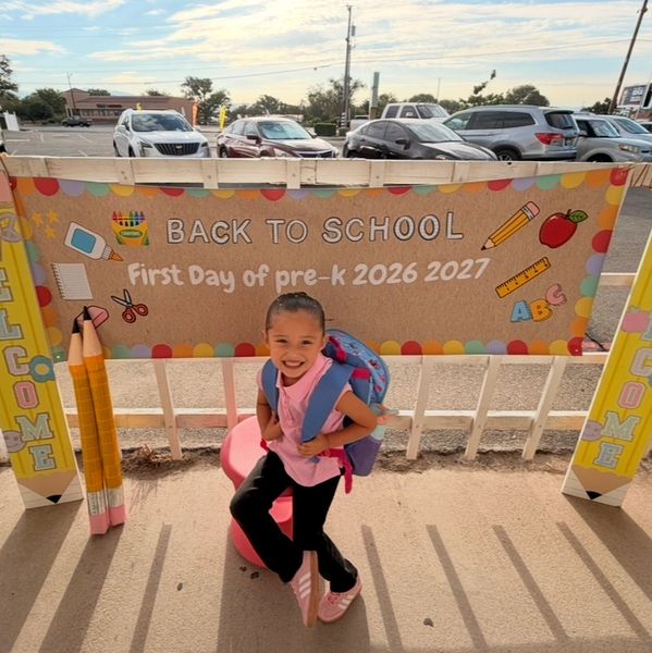 Smiling child with backpack ready for first day of pre-K.