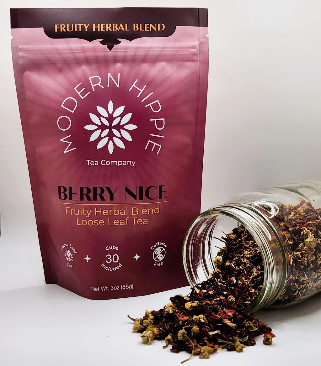 Berry nice tea blend - red colored package with loose leaf tea poured out