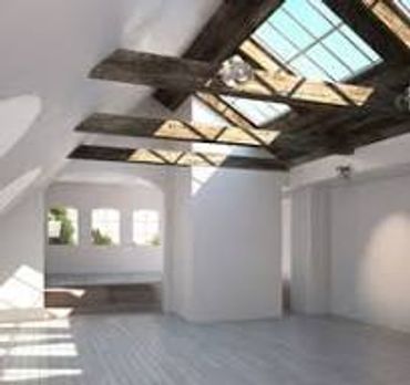 Bright, spacious room with skylights and exposed wooden beams.