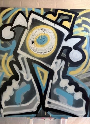 Colorful abstract graffiti featuring a central circular motif and bold shapes.