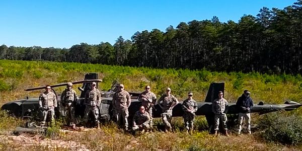 U.S Special Forces ASDAT / JCAT Team in front of a crashed Cobra Helicopter during exercises.  