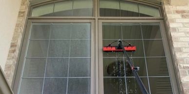 Before and after cleaning exterior glass with water fed pole.