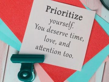 A sign that reads: Prioritize yourself. You deserve time, love, and attention too.