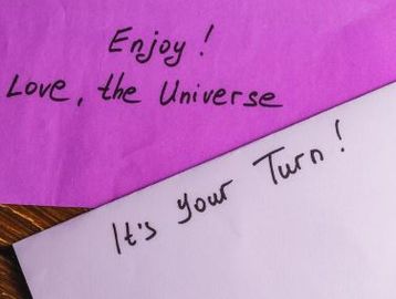 A purple piece of paper that reads: Enjoy! Love, the Universe. Also a lavendar piece of paper that r