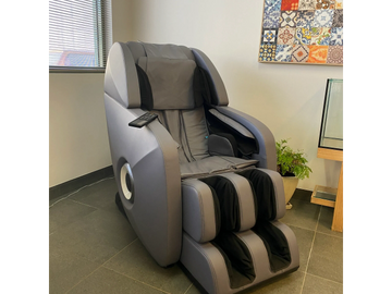 Massage chair with deep pressure calming at sensory hub cafe space. fish tank for relaxation