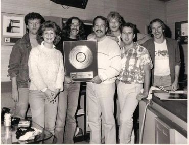 CFox days! Triumph’s bassist, Mike Levine, receives a gold record on behalf of the band