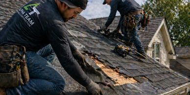 Workers repairing a damaged roof