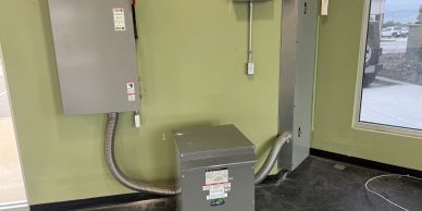 Electrical control room with transformers and circuit boxes.
