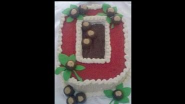 A number 9 shaped cake decorated with flowers and leaves.