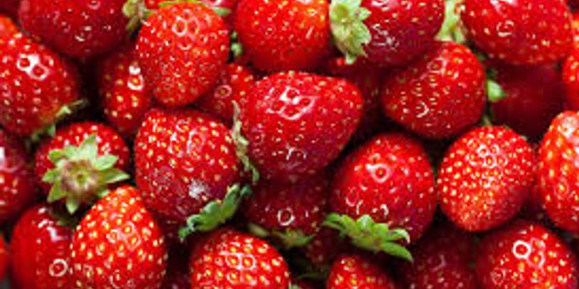 Fresh, juicy red strawberries piled together.