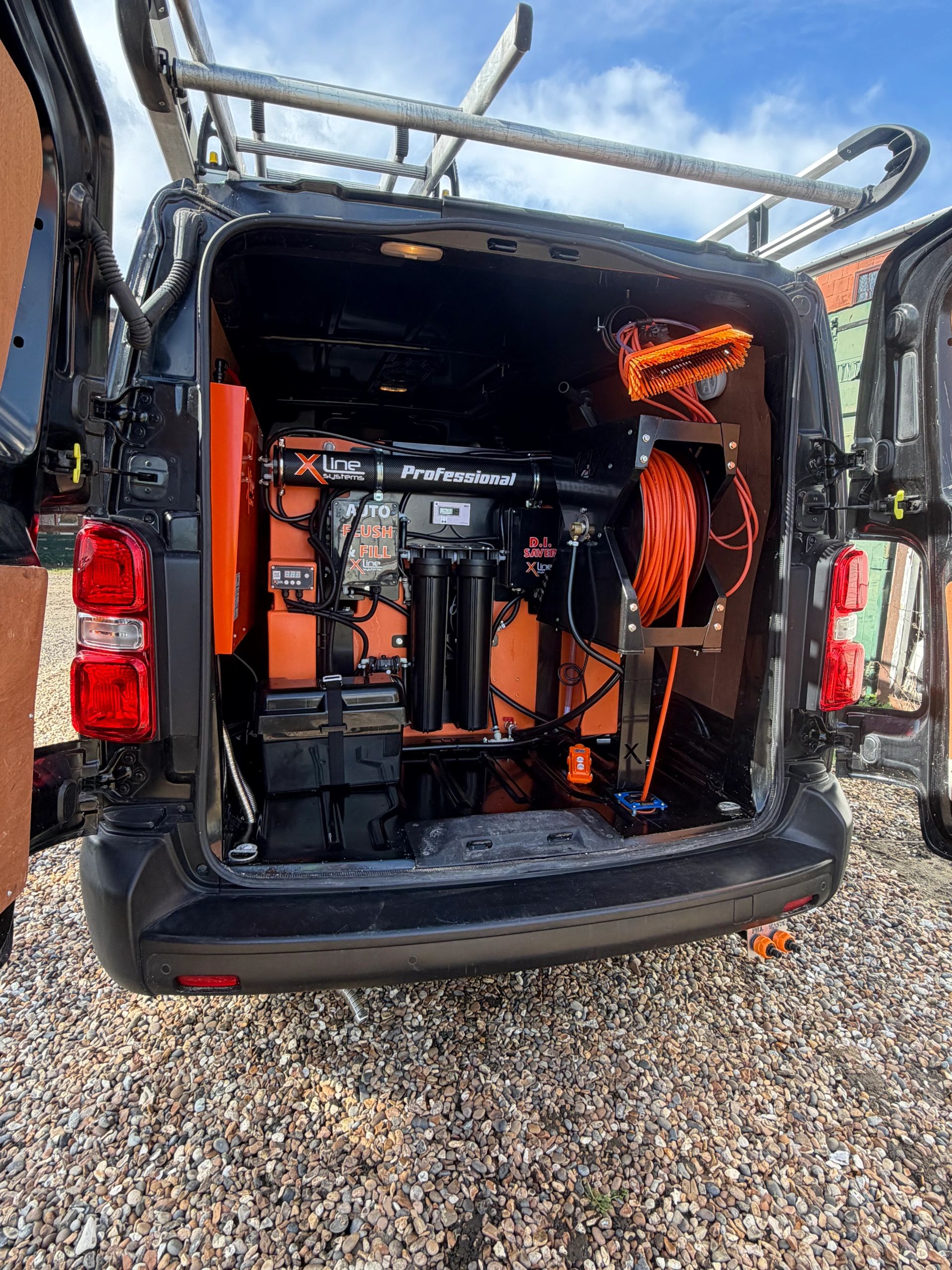 professional hot-water reach-and-wash window cleaning system installed in our service van.