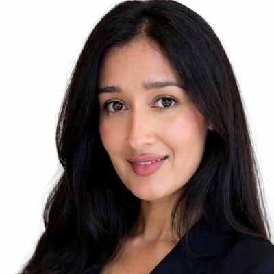 Portrait of a confident woman with long black hair and a subtle smile.