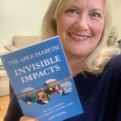 Sarah with her book "Invisible Impacts"
