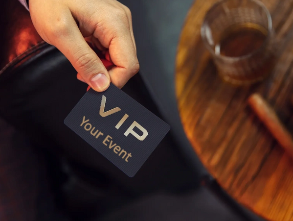 Hand holding a VIP card for an event.