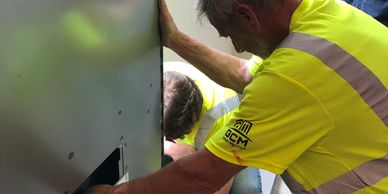 Two men working on structure.