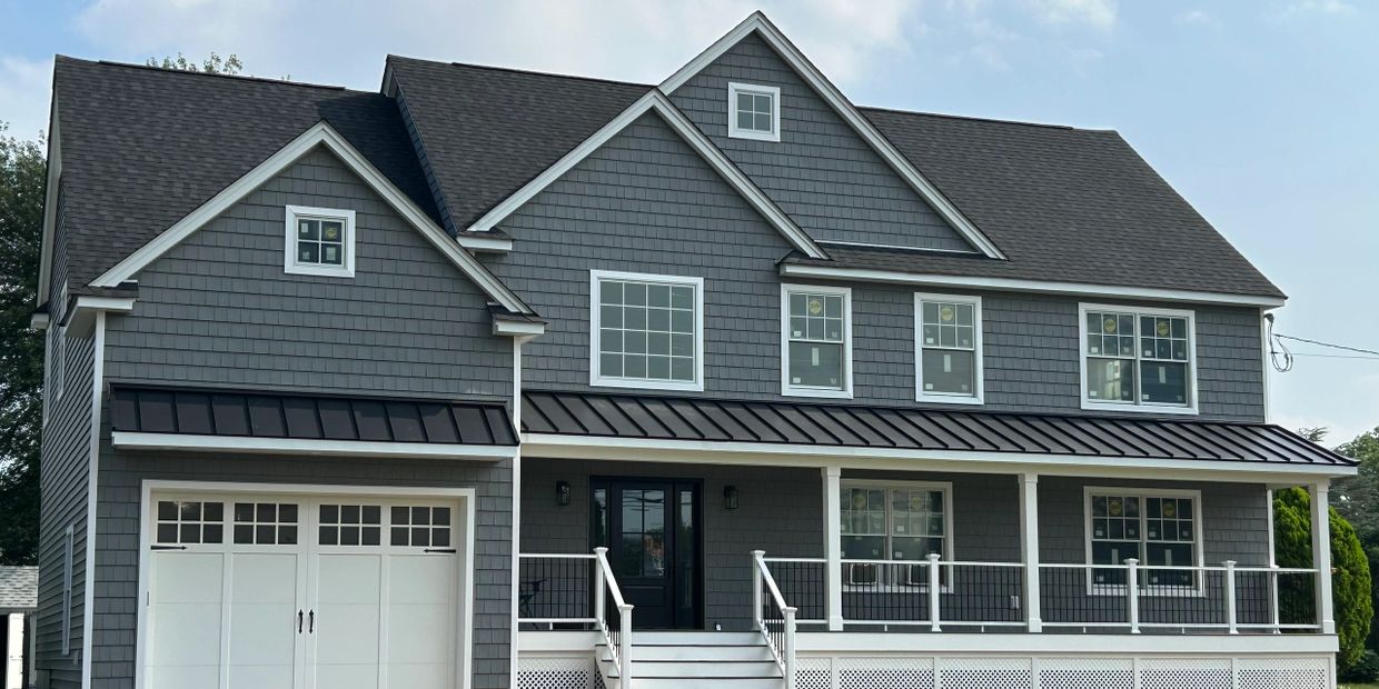 Modern two-story gray house with white trim and a front porch.