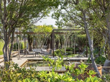 Outdoor patio with seating and greenery.
