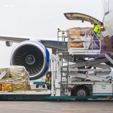 Air cargo being loaded onto an airplane at the airport.