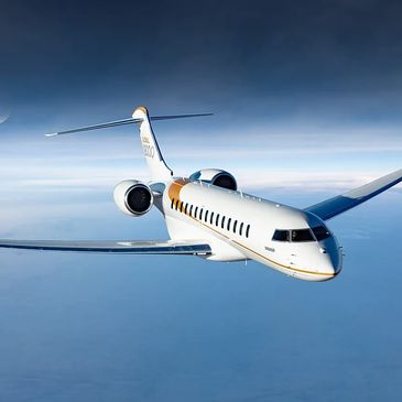 Luxury private jet flying high above the clouds during daytime.