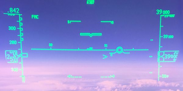 Flight instrument HUD displaying altitude and speed above clouds.